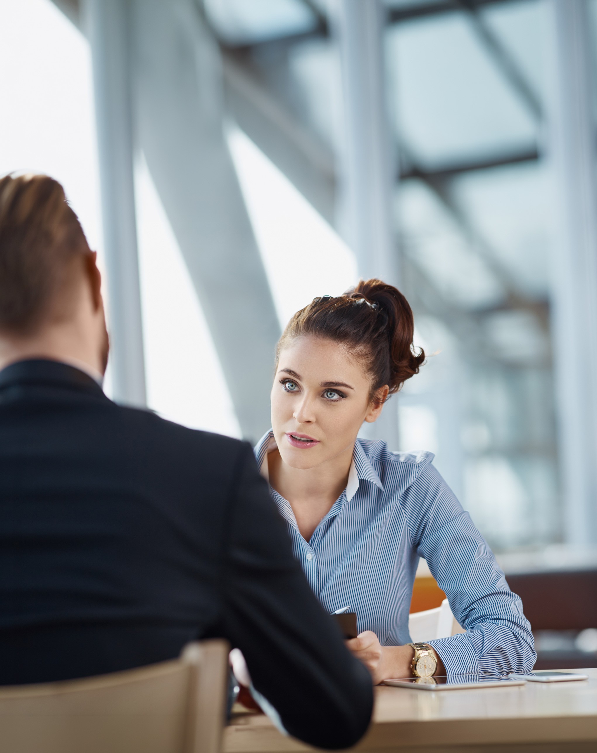 Woman discussing work with a colleague at a table