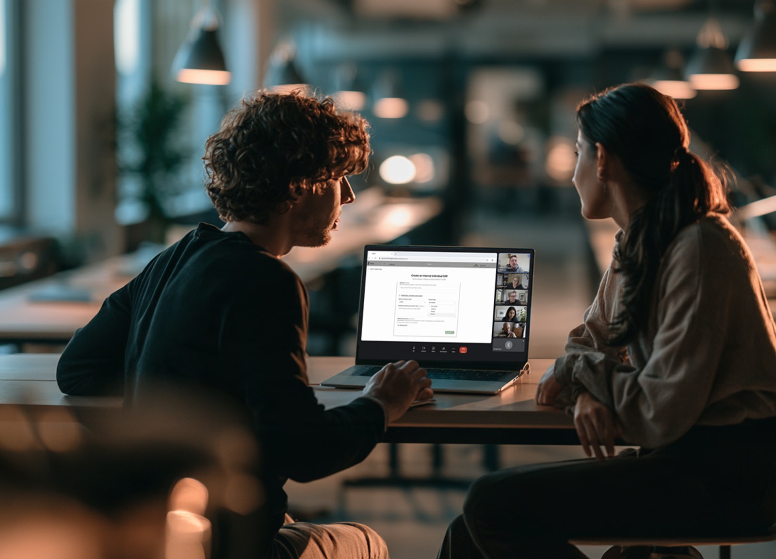 Two colleagues working through a session together on a laptop.